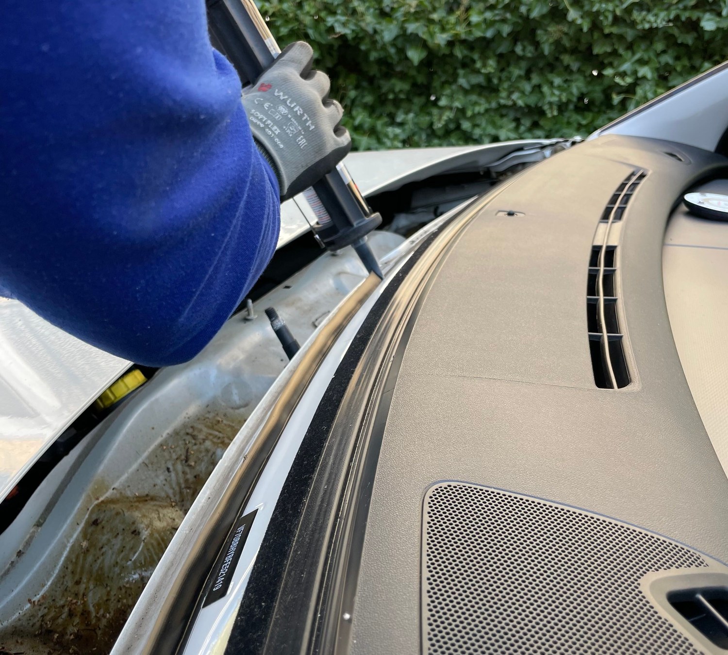Technician bonding a replacement windshield at AUTOSTREAM360 in Centennial CO