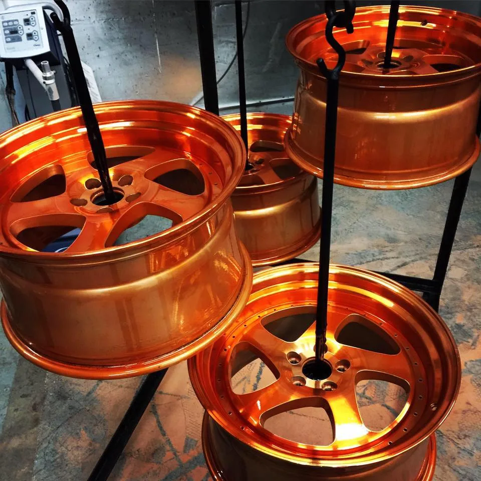 Orange powder-coated rims refinished at AUTOSTREAM360