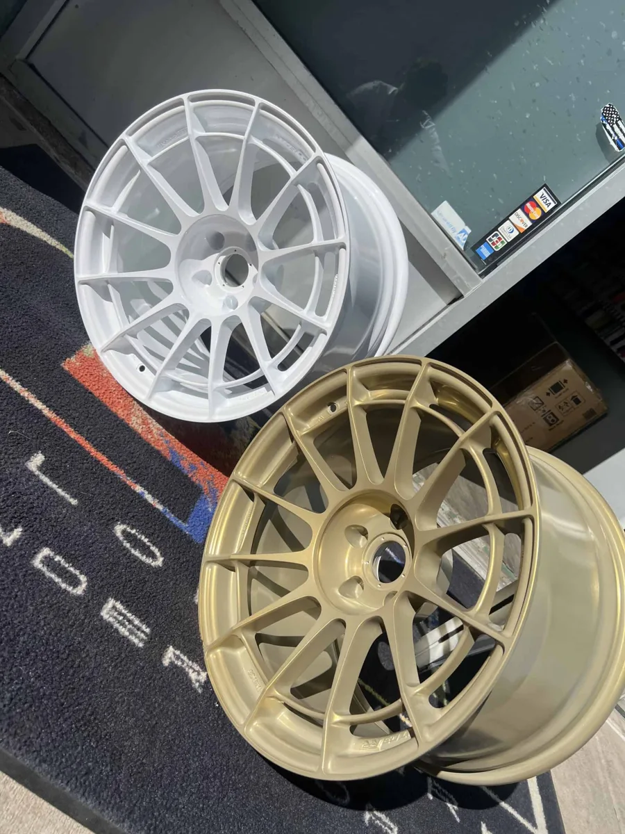 White and gold powder-coated wheels refinished at AUTOSTREAM360