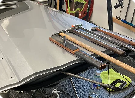 Glue-pull dent repair tabs on a hood at AUTOSTREAM360