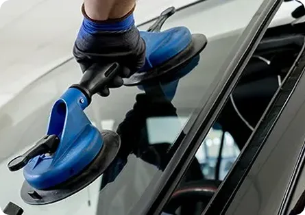 Windshield being fitted with suction-cup tools at AUTOSTREAM360