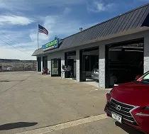 An AUTOSTREAM360 shop exterior with the repair bay doors open